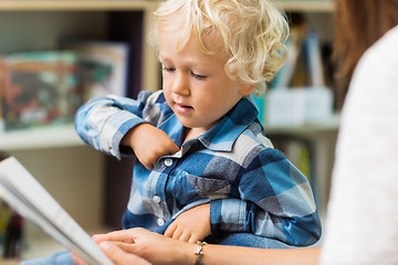 Image showing Boy With Teacher Reading Book