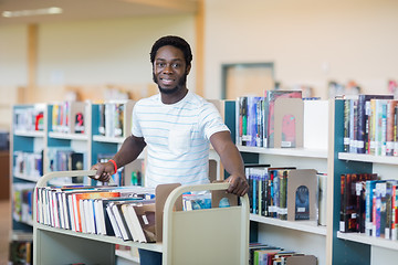 Image showing Librarian With Trolley Of Books In Library