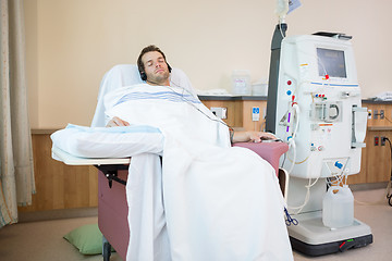 Image showing Patient Sleeping While Listening Music at Dialysis Center