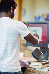 Image showing Librarian Scanning Books At Library Counter