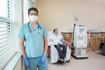 Image showing Nurse In Protective Clothing With Patient Receiving Dialysis