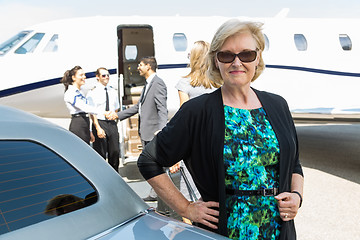 Image showing Confident Businesswoman Against Private Jet