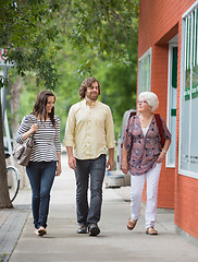 Image showing Smiling Friends Walking On Pavement