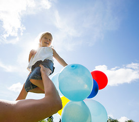 Image showing Mother Lifting Daughter Against Cloudy Sky