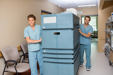 Image showing Nurse Pushing Trolley While Colleague Assisting Him In Hallway