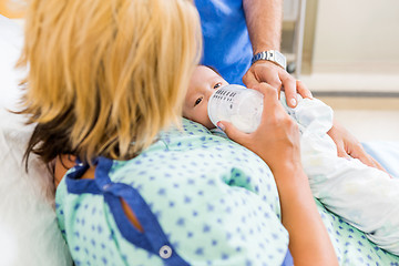 Image showing Woman Feeding Milk To Newborn Babygirl On Hospital Bed