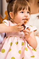 Image showing Birthday Girl Eating Cake With Icing On Her Face