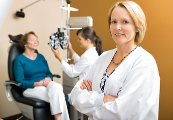 Image showing Confident Ophthalmologist With Colleague Examining Patient