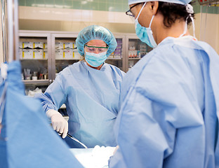 Image showing Multiethnic Surgeons Operating on Patient