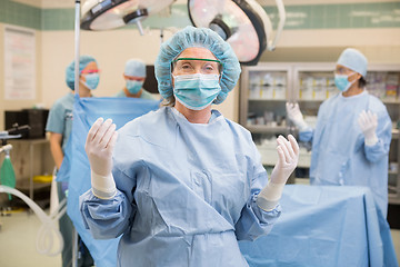 Image showing Doctor In Surgical Gown With Team At Operation Room