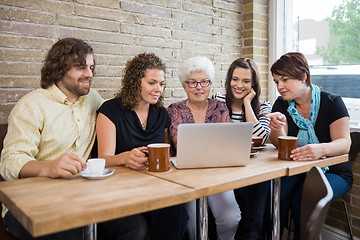 Image showing Woman With Friends Using Laptop At Coffeeshop