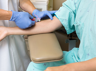 Image showing Doctor Drawing Blood From Female Patient's Arm