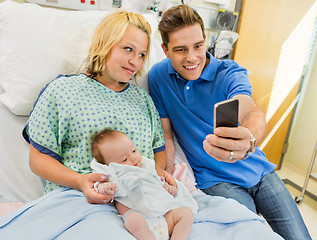 Image showing Man With Woman And Babygirl Taking Selfportrait Through Mobile P