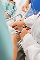 Image showing Doctor Examining Newborn Babygirl In Hospital