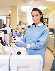 Image showing Medical lab tech performing urine analysis in lab