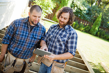 Image showing Workers Discussing Project On Digital Tablet At Site