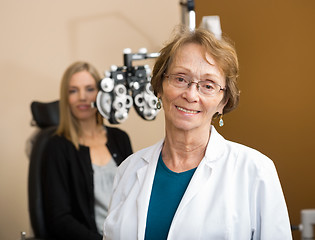 Image showing Female Optometrist With Patient In Background