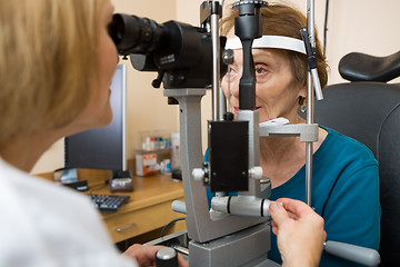 Image showing Optometrist Examining Senior Woman's Eyes