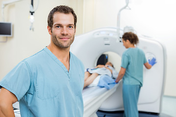 Image showing Nurse With Colleague Preparing Patient For CT Scan In Hospital