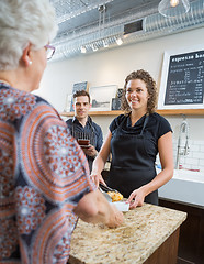 Image showing Workers Looking At Senior Woman In Cafeteria