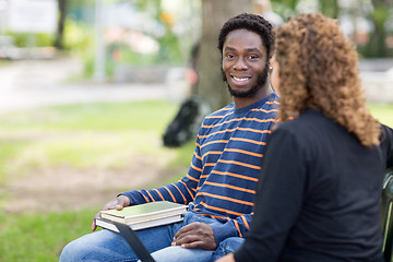 Image showing Male Student Sitting With Female Friend On Campus