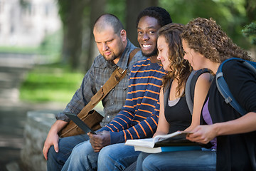 Image showing University Student Sitting With Friends On Campus