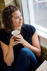 Image showing Woman Looking Through Window In CafÃ©