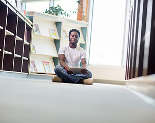 Image showing Male Student With Digital Tablet Sitting In Library