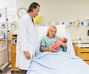 Image showing Mother Holding Newborn Babygirl While Doctor Standing By In Hosp