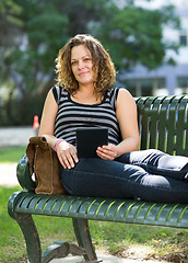 Image showing Confident University Student Sitting On Bench