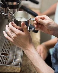 Image showing Barista Steaming Milk In Coffeeshop