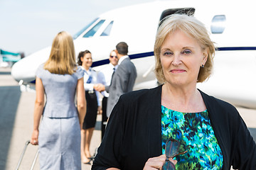 Image showing Portrait Of Confident Businesswoman Against Private Jet