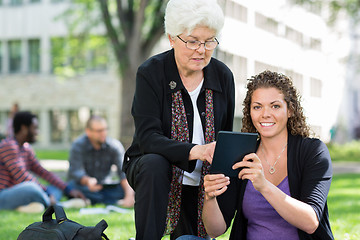 Image showing Female University Student Using Digital Tablet With Friend