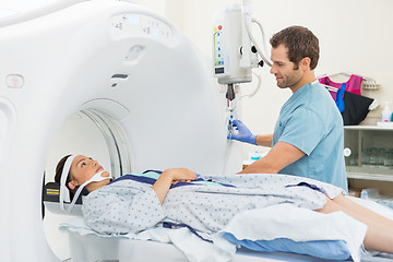 Image showing Nurse Looking At Patient Undergoing CT Scan