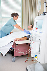 Image showing Nurse Setting up Dialysis on male patient