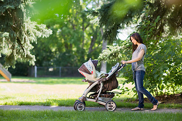 Image showing Mother Pushing Stroller In The Park