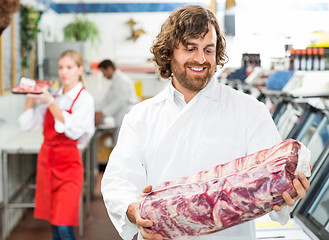 Image showing Happy Butcher Looking At Meat Package