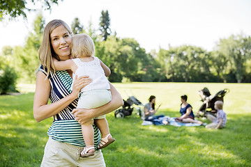 Image showing Happy Mother Carrying Daughter At Park