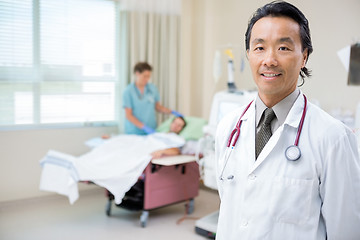 Image showing Doctor In Hospital Room With Nurse Giving Dialysis To Patient