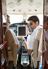 Image showing Pilots Using Digital Tablet In Cockpit