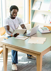 Image showing Student Using Technologies While Studying In Library