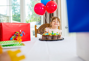 Image showing Birthday Girl Looking At Presents At Home