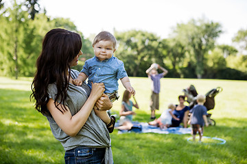 Image showing Happy Mother Carrying Son In Park