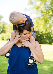 Image showing Woman Carrying Son On Shoulders In Park