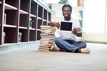 Image showing Smiling Student With Books Showing Digital Tablet In Library