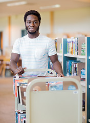 Image showing Librarian With Trolley Of Books In Library