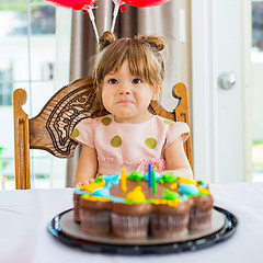Image showing Birthday Girl Sitting In Front Of Cake