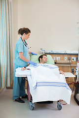 Image showing Nurse Standing By Patient Receiving Renal Dialysis