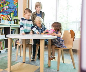 Image showing Children Using Digital Tablet At Table In Library