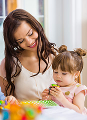 Image showing Mother With Birthday Girl Eating Cupcake